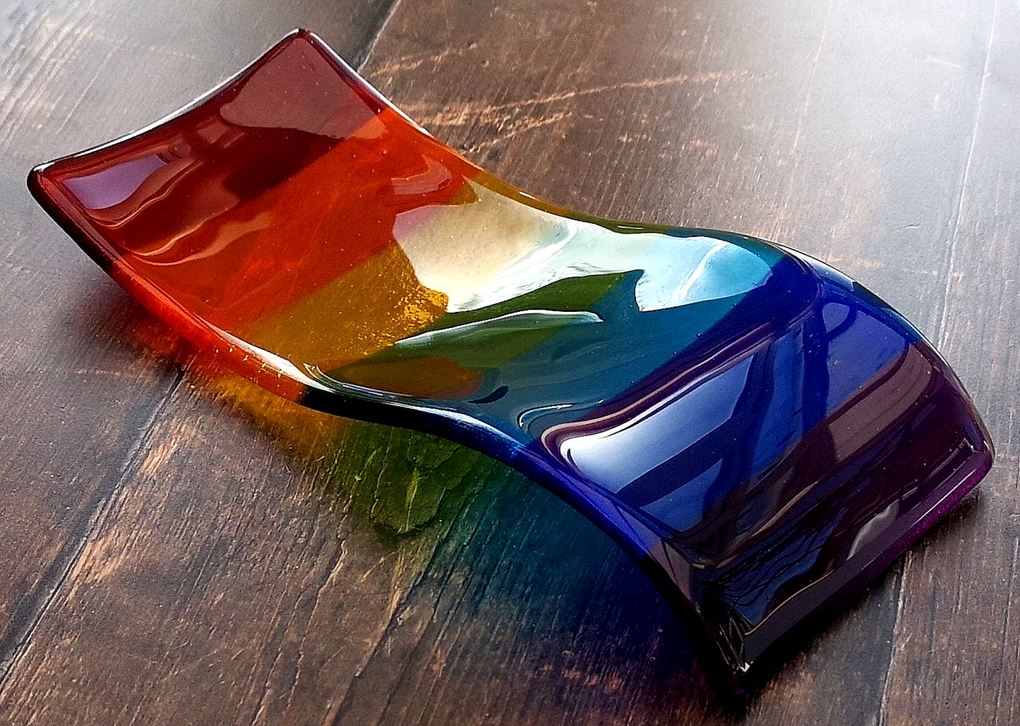 Handmade fused glass free standing Rainbow Curved Picture Suncatcher or Spoon Rest. Brightly coloured wavy light catcher, rainbow decor.