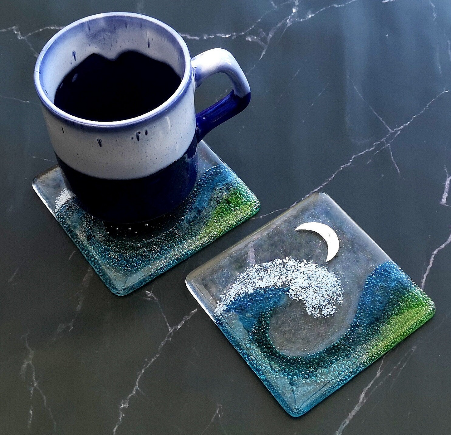 Handmade fused glass wave drinks coaster with embedded coloured bubbles and pure silver foil moon. Glass wall tile, hot drink table mat, sea, ocean home decoration, dining table protection. Beach gift.