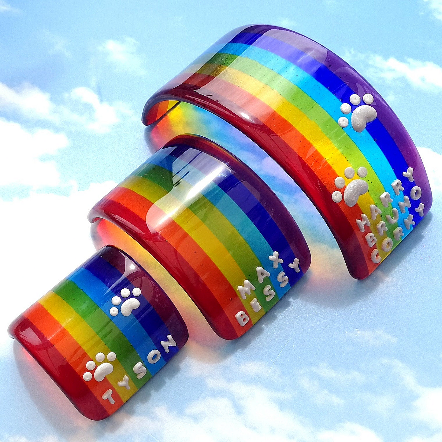 Handmade fused glass curved rainbow bridge. 3D pet paw prints. Free standing personalised 3D name rainbow arch. Brightly coloured glass gift. Suncatcher, light catcher. Gift for pet loss, remembrance.