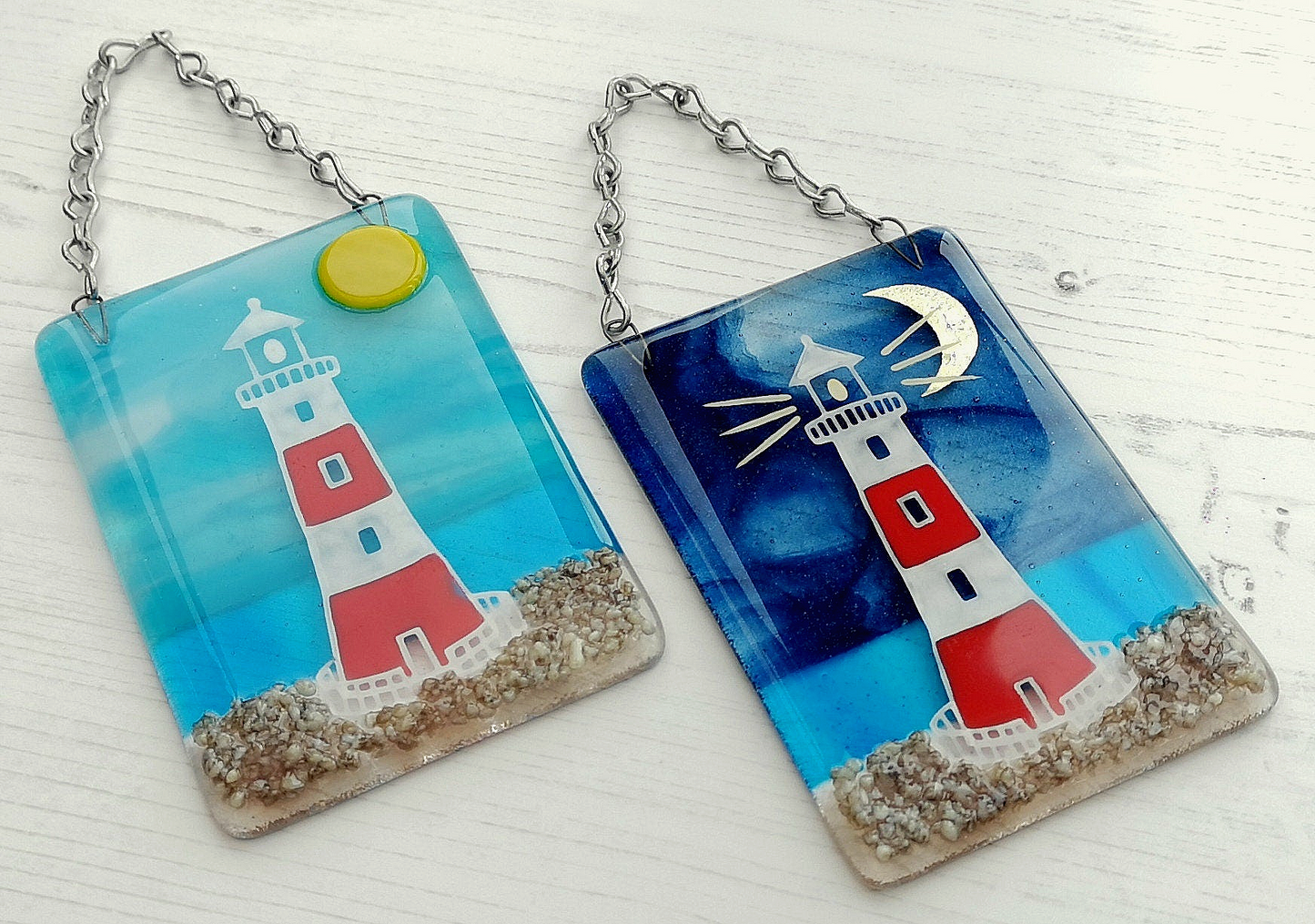 Handmade fused glass 3D Lighthouse Hanging Picture. Seaside suncatcher wall art, beach gift decoration, sea ocean scene with glass pebbles, red & white light house, sun and blue sky or silver moon and night sky.