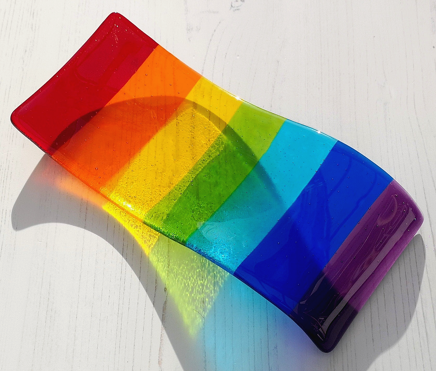 Handmade fused glass free standing Rainbow Curved Picture Suncatcher or Spoon Rest. Brightly coloured wavy light catcher, rainbow decor.