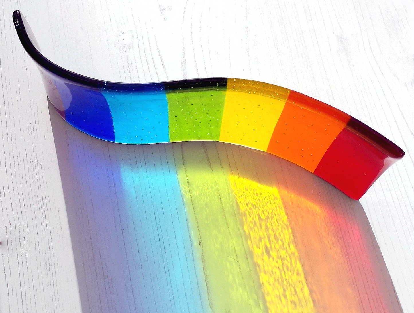 Handmade fused glass free standing Rainbow Curved Picture Suncatcher or Spoon Rest. Brightly coloured wavy light catcher, rainbow decor.