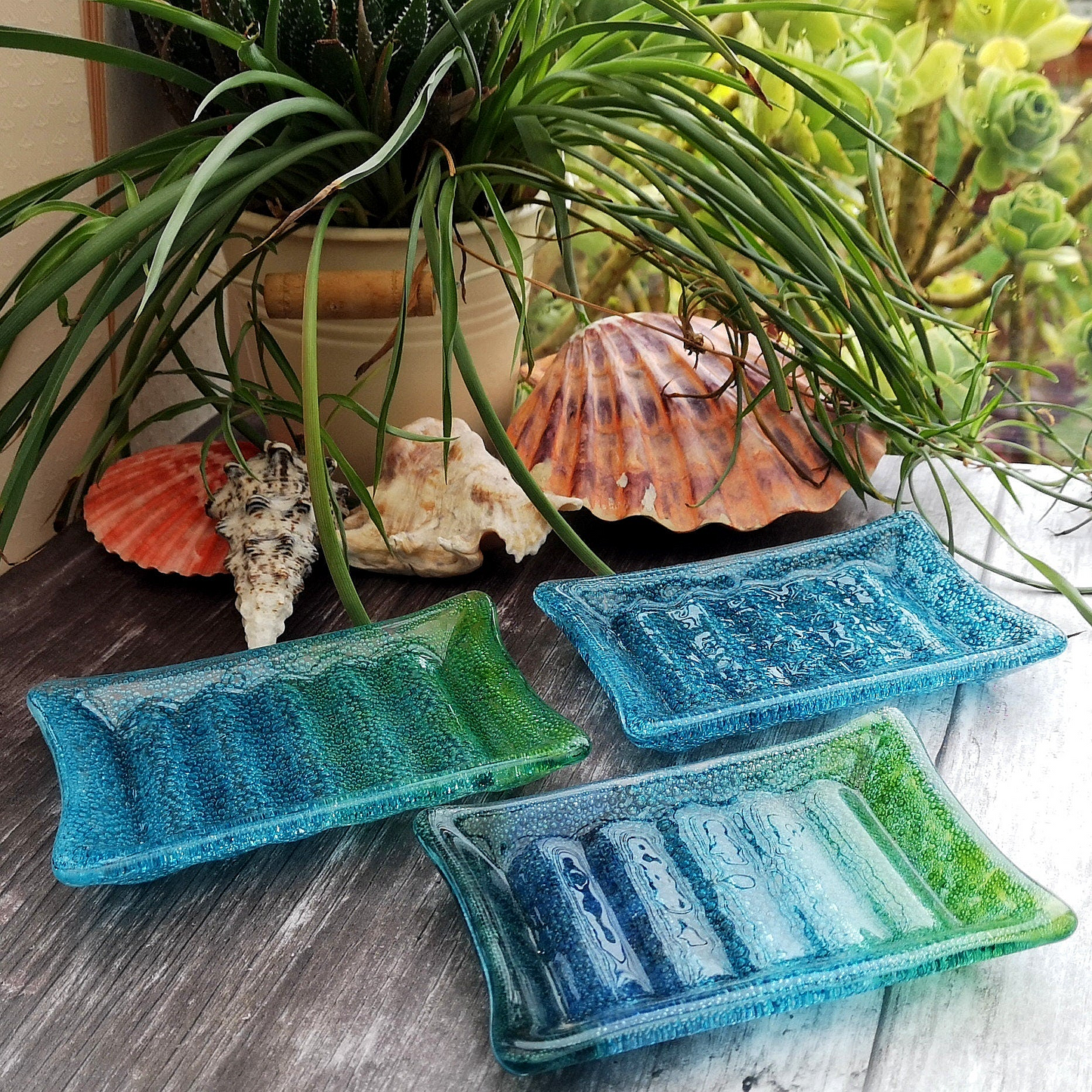 Handmade fused glass soap dish with bubbles encased inside the glass. Turquoise blue to green embedded coloured bubbles. Colourful bubbly glass soap holder. Brightly Coloured Gift.