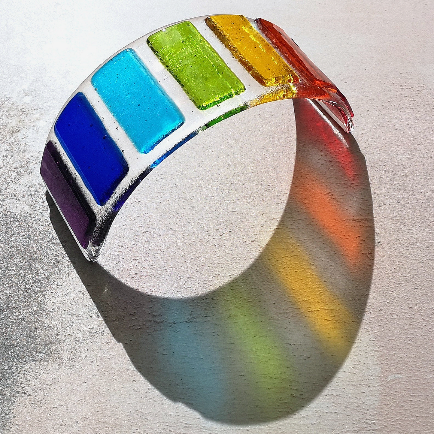 Handmade fused glass curved rainbow bridge. 3D pet paw prints. Free standing personalised 3D name rainbow arch. Brightly coloured glass gift. Suncatcher, light catcher. Gift for pet loss, remembrance.