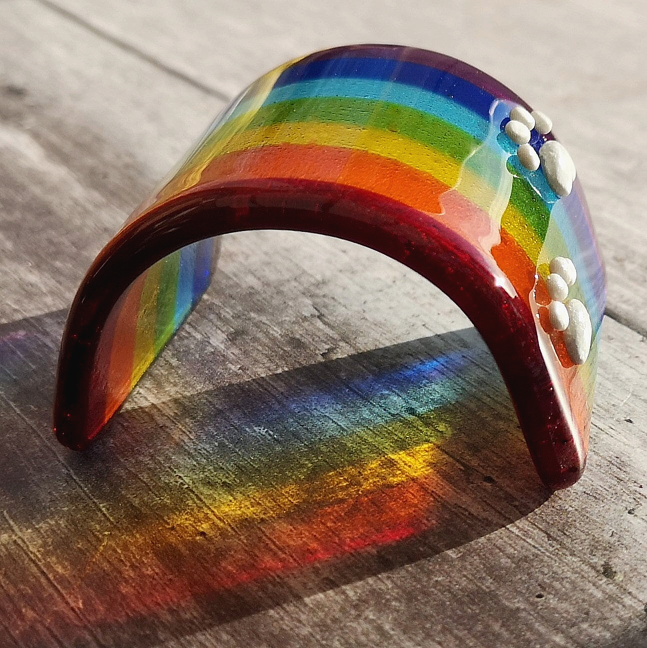 Handmade fused glass curved rainbow bridge. 3D pet paw prints. Free standing personalised 3D name rainbow arch. Brightly coloured glass gift. Suncatcher, light catcher. Gift for pet loss, remembrance.