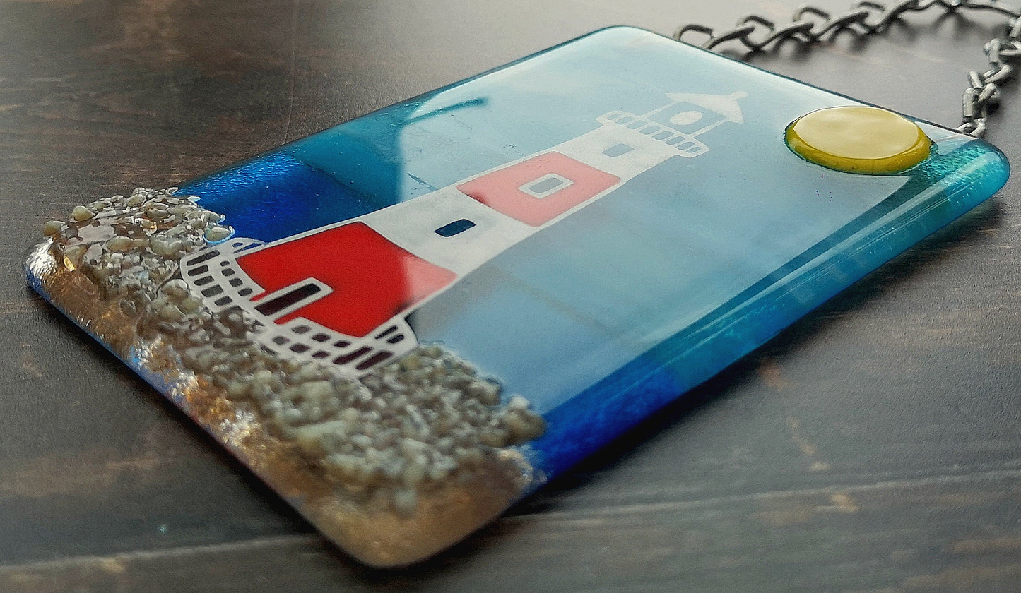 Handmade fused glass 3D Lighthouse Hanging Picture. Seaside suncatcher wall art, beach gift decoration, sea ocean scene with glass pebbles, red & white light house, sun and blue sky or silver moon and night sky.