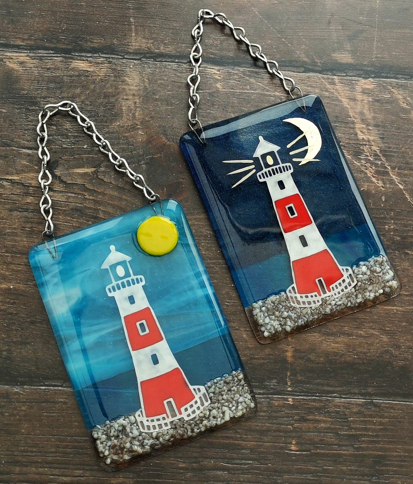 Handmade fused glass 3D Lighthouse Hanging Picture. Seaside suncatcher wall art, beach gift decoration, sea ocean scene with glass pebbles, red & white light house, sun and blue sky or silver moon and night sky.