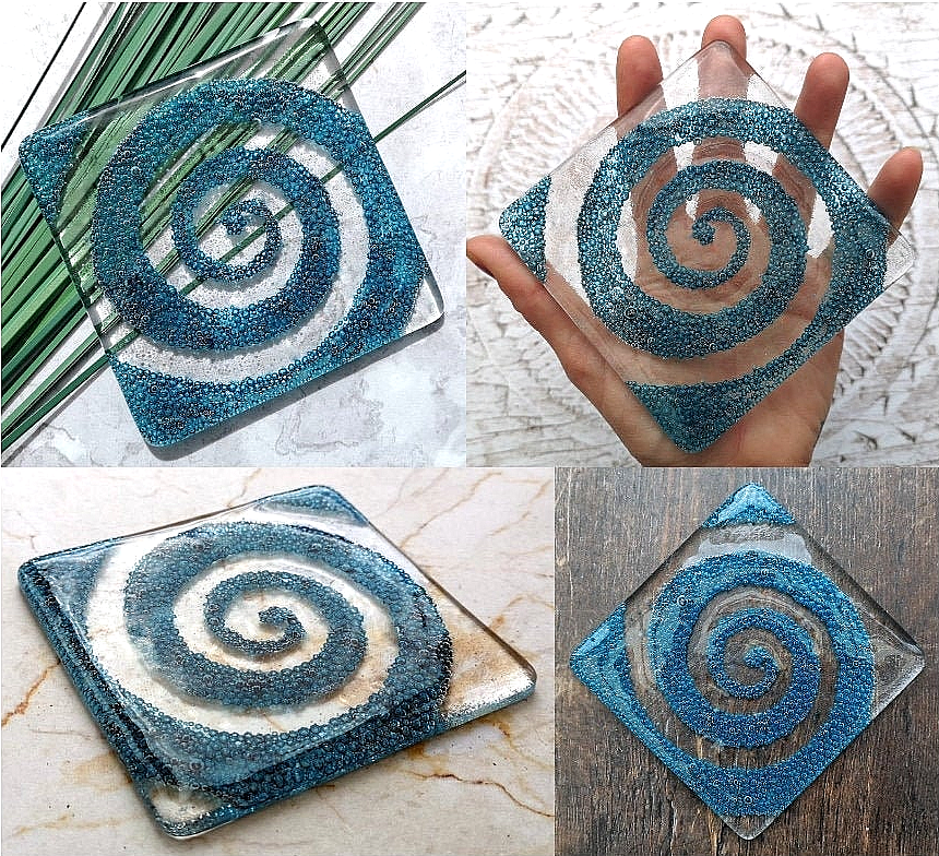 Handmade fused glass spiral drinks coaster with embedded coloured bubbles. Glass wall tile, hot drink table mat, twirl design, swirly pattern gift. Bubbly home decoration, dining table protection.
