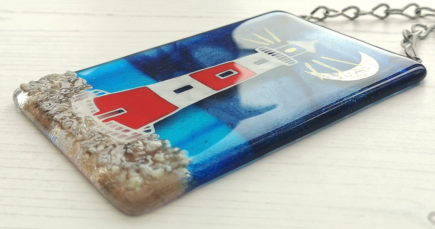 Handmade fused glass 3D Lighthouse Hanging Picture. Seaside suncatcher wall art, beach gift decoration, sea ocean scene with glass pebbles, red & white light house, sun and blue sky or silver moon and night sky.