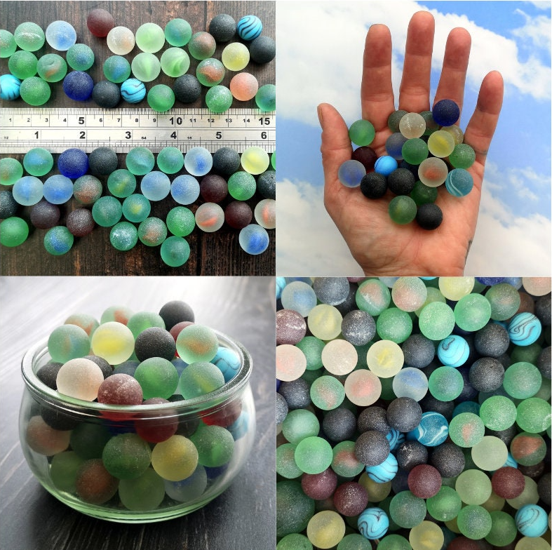 Artistic display of multicoloured tumbled glass marbles, set out to inspire creative DIY projects, emphasizing their size variety and visual appeal