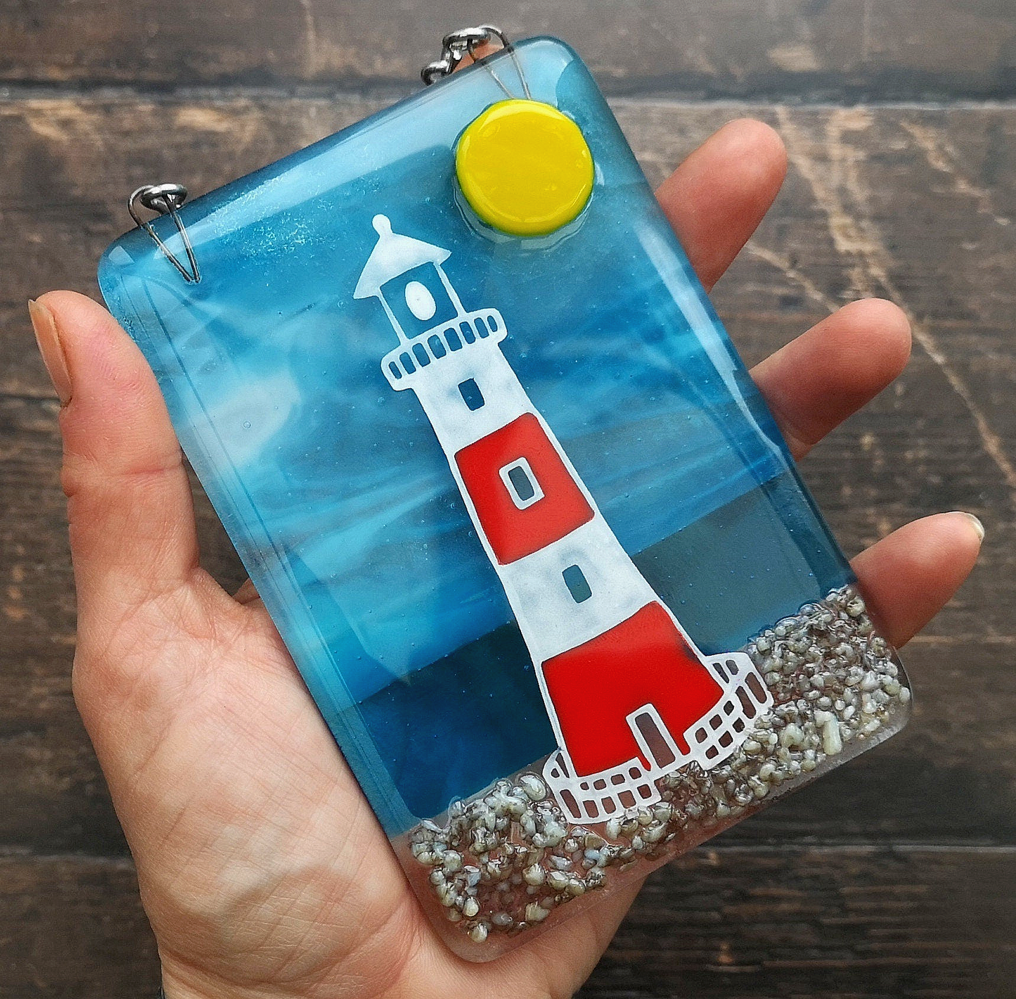 Handmade fused glass 3D Lighthouse Hanging Picture. Seaside suncatcher wall art, beach gift decoration, sea ocean scene with glass pebbles, red & white light house, sun and blue sky or silver moon and night sky.