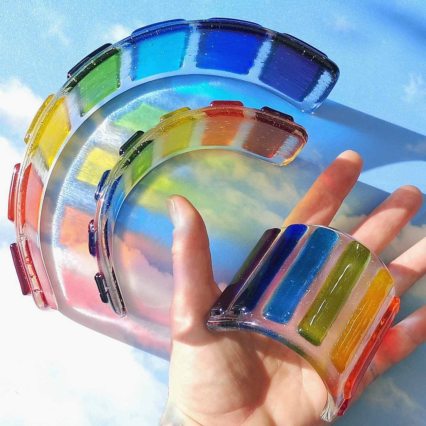 Handmade fused glass curved rainbow bridge. 3D pet paw prints. Free standing personalised 3D name rainbow arch. Brightly coloured glass gift. Suncatcher, light catcher. Gift for pet loss, remembrance.