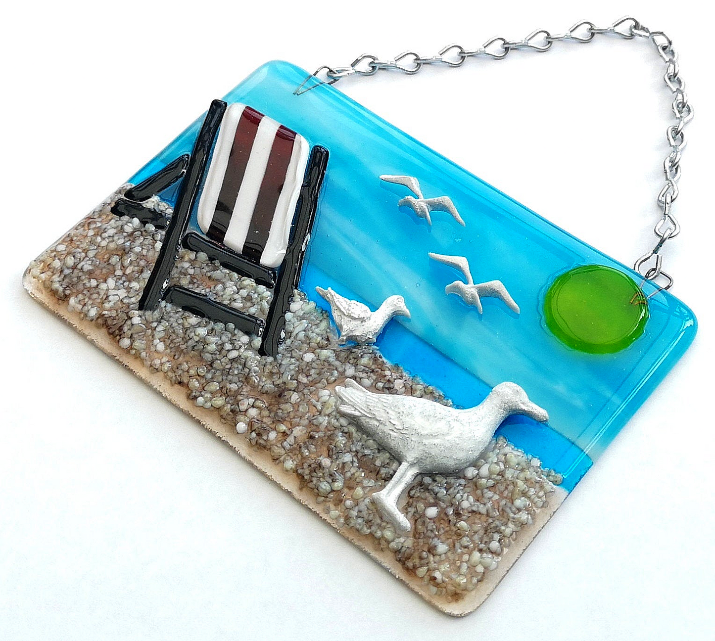 Handmade fused glass 3D Seagull & Deckchair Hanging Picture. Seaside suncatcher wall art, beach gift decoration, sea ocean scene with glass pebbles, sea birds, sun and blue sky.