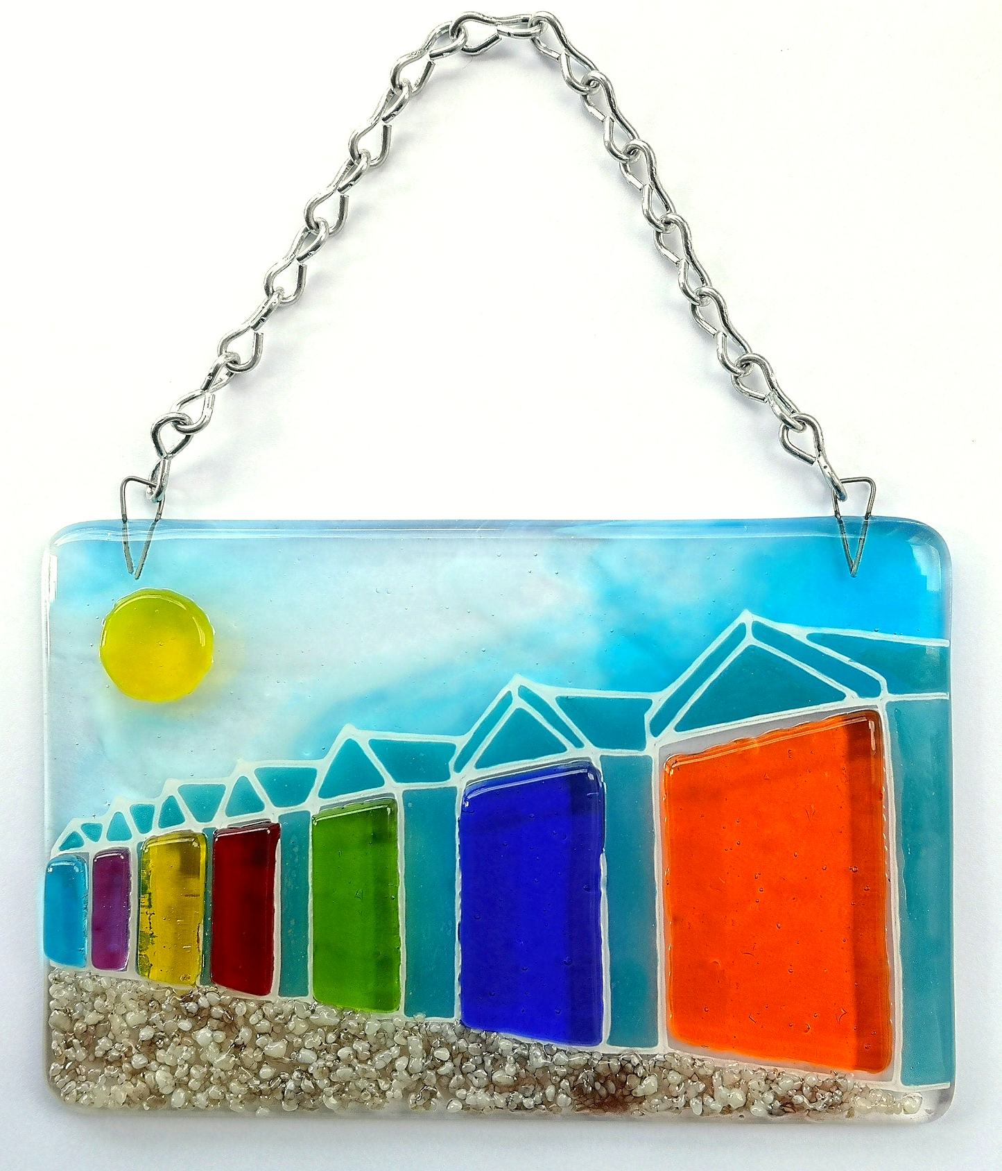 Handmade fused glass 3D Beach Huts Hanging Picture. Seaside suncatcher wall art, beach gift decoration, sea ocean scene with glass pebbles, rainbow coloured beach huts, sun and blue sky.