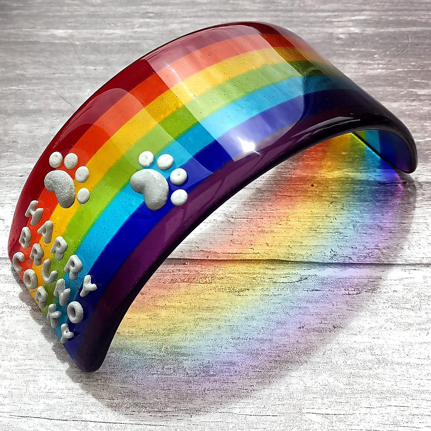 Handmade fused glass curved rainbow bridge. 3D pet paw prints. Free standing personalised 3D name rainbow arch. Brightly coloured glass gift. Suncatcher, light catcher. Gift for pet loss, remembrance.