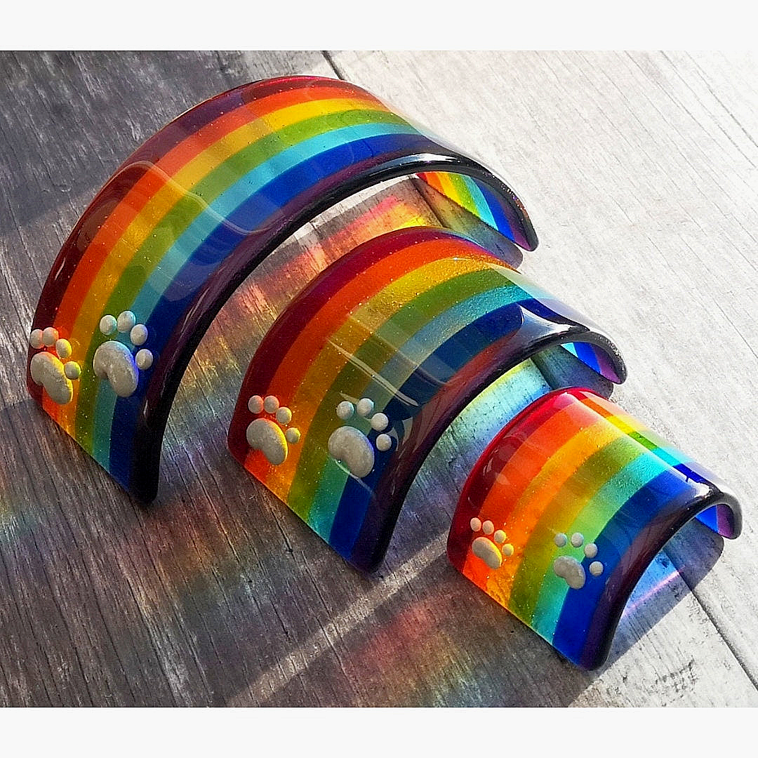 Handmade fused glass curved rainbow bridge. 3D pet paw prints. Free standing personalised 3D name rainbow arch. Brightly coloured glass gift. Suncatcher, light catcher. Gift for pet loss, remembrance.