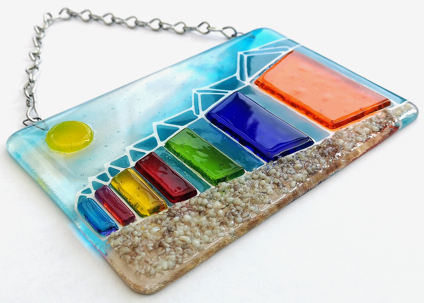Handmade fused glass 3D Beach Huts Hanging Picture. Seaside suncatcher wall art, beach gift decoration, sea ocean scene with glass pebbles, rainbow coloured beach huts, sun and blue sky.