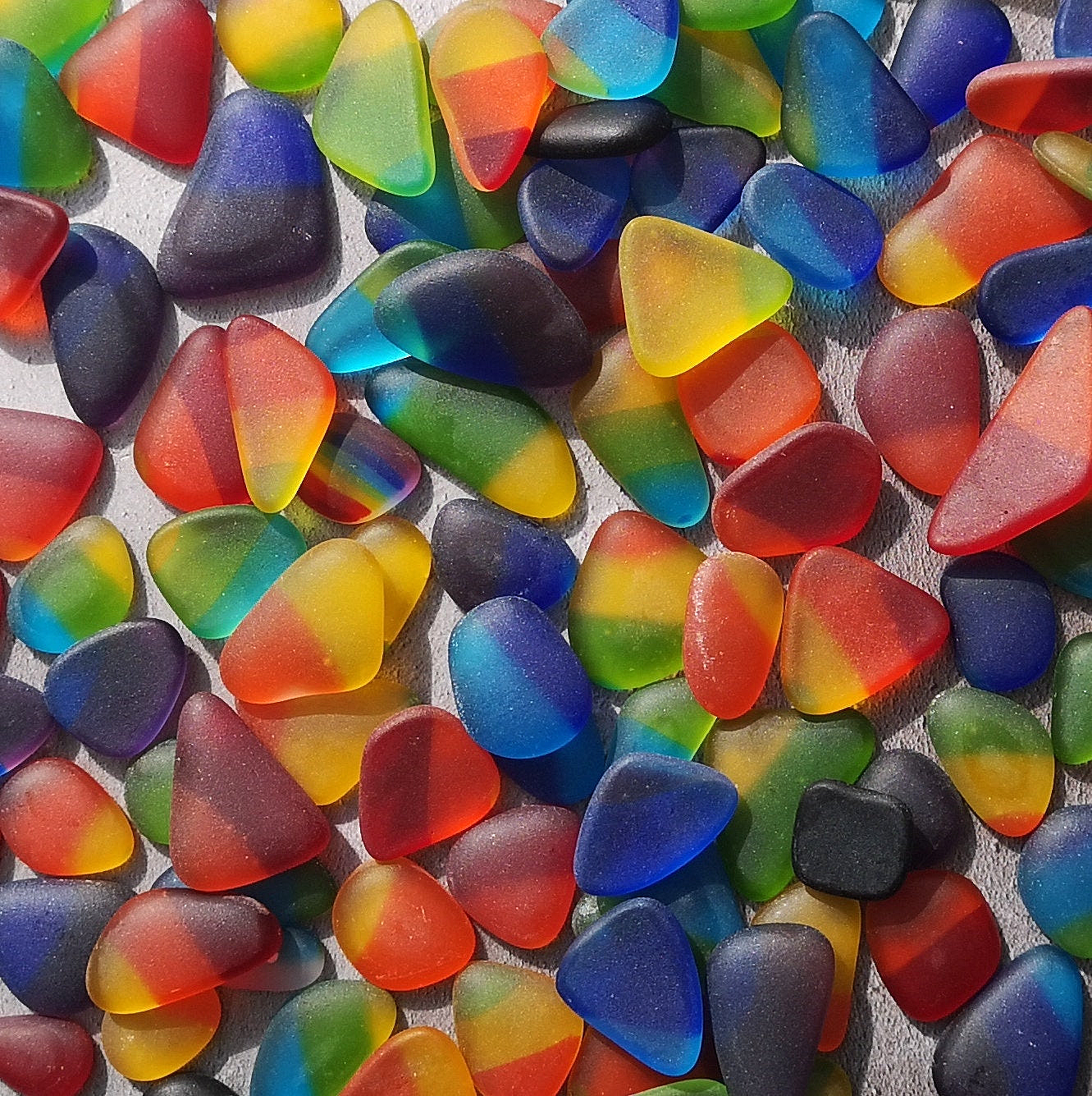 Sustainable multi coloured tumbled glass collection, environmental friendliness, recycled glass