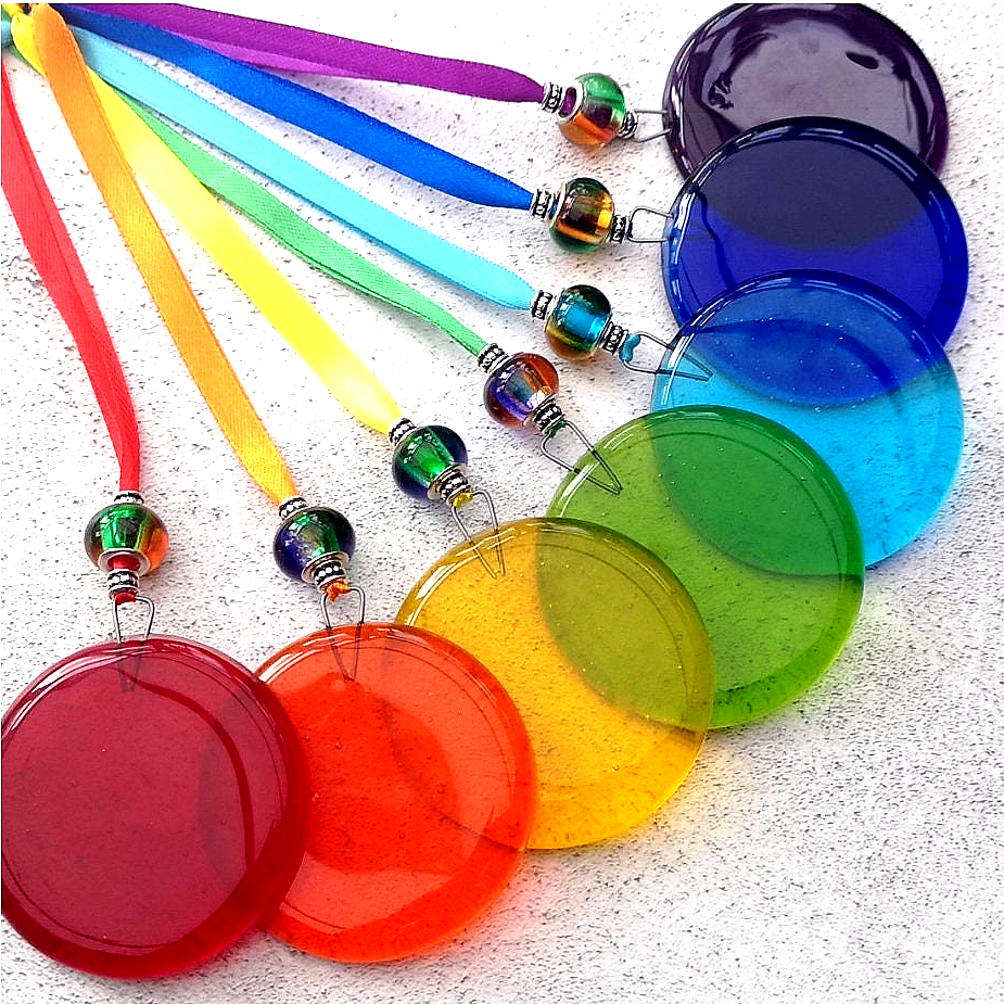 Handmade fused glass round rainbow coloured hanging Christmas tree decoration. Glass suncatcher bauble ornament, holiday decor gift, festive present.