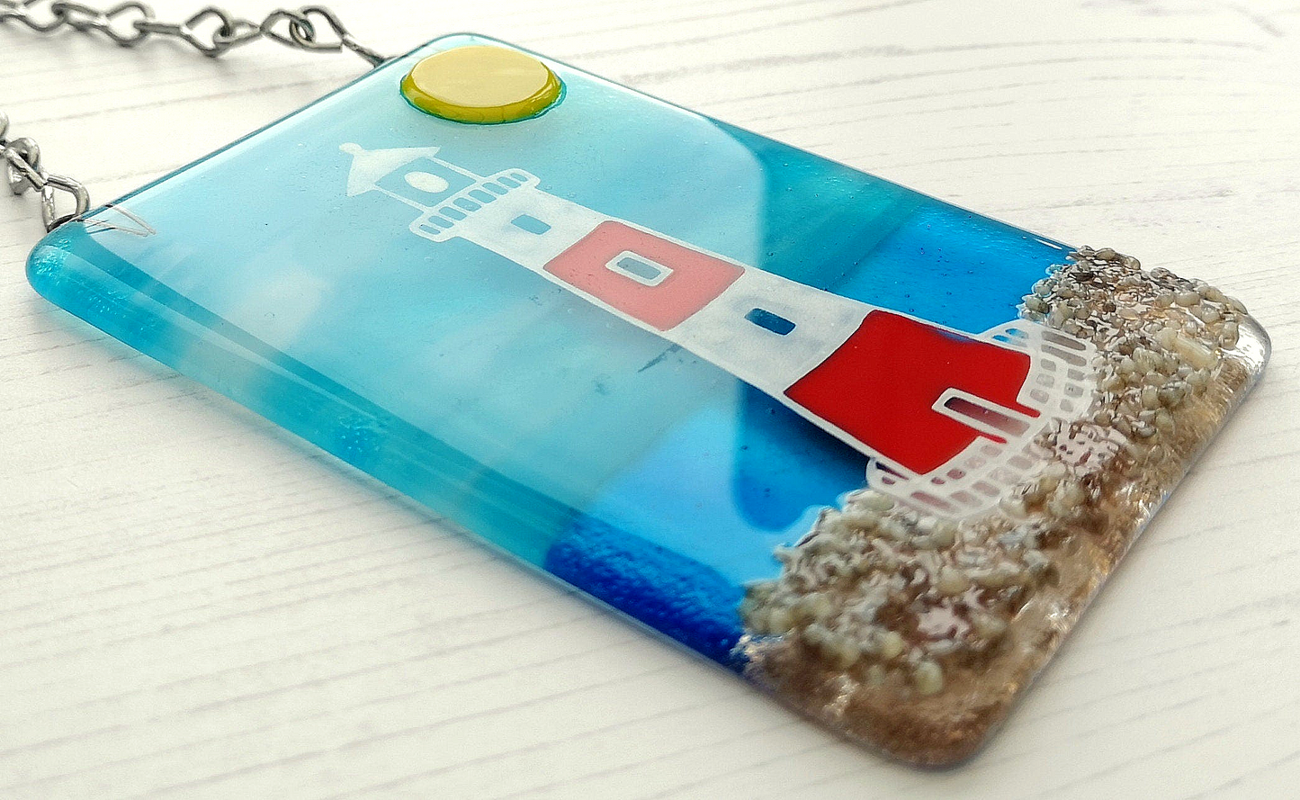 Handmade fused glass 3D Lighthouse Hanging Picture. Seaside suncatcher wall art, beach gift decoration, sea ocean scene with glass pebbles, red & white light house, sun and blue sky or silver moon and night sky.