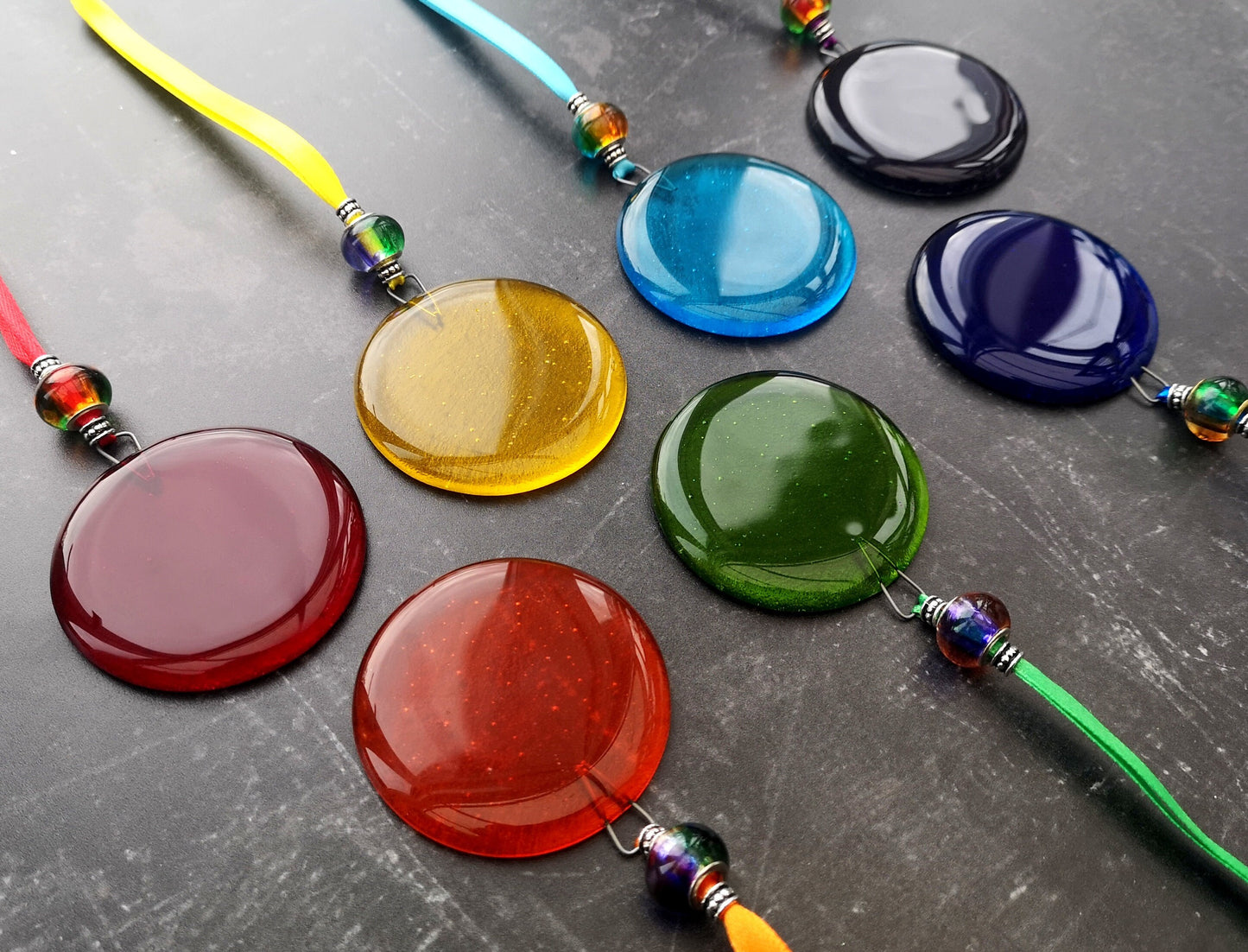 Handmade fused glass round rainbow coloured hanging Christmas tree decoration. Glass suncatcher bauble ornament, holiday decor gift, festive present.