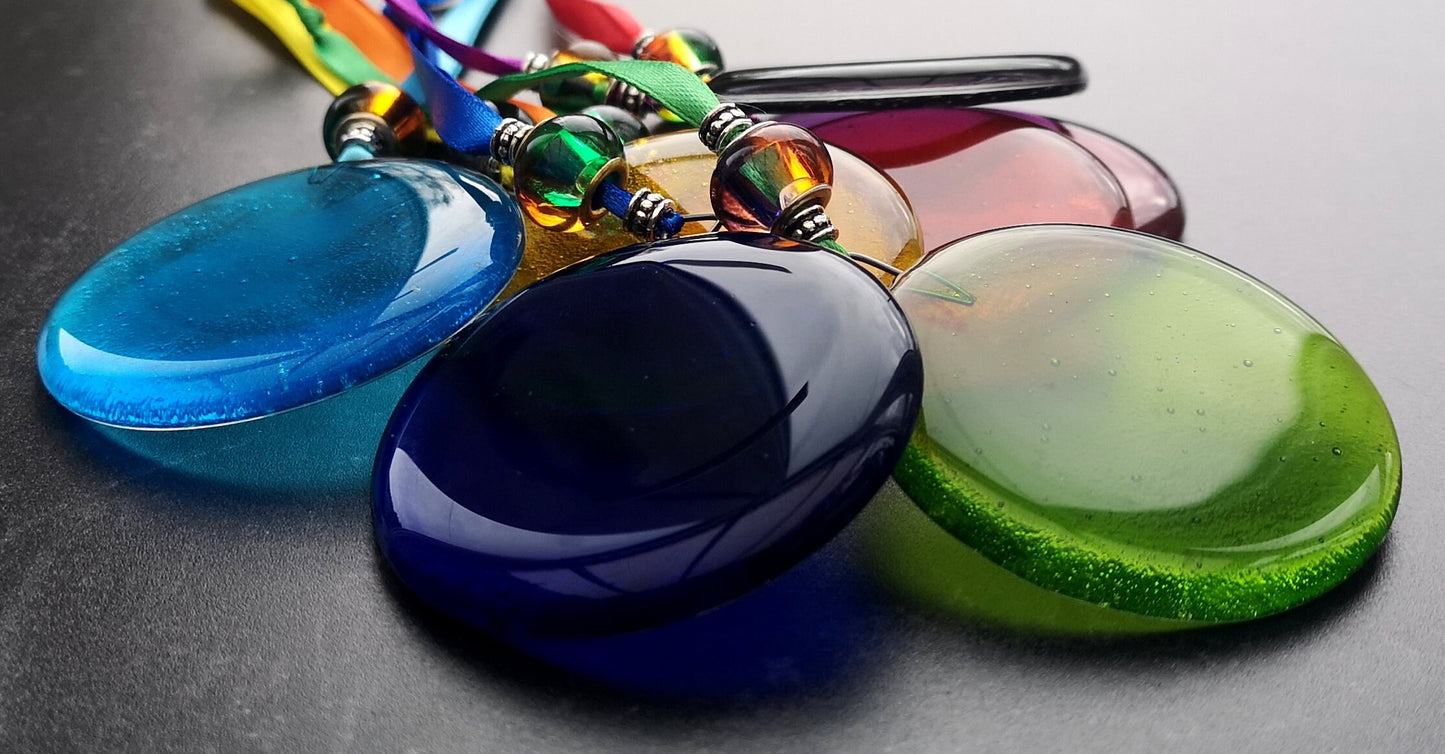 Handmade fused glass round rainbow coloured hanging Christmas tree decoration. Glass suncatcher bauble ornament, holiday decor gift, festive present.