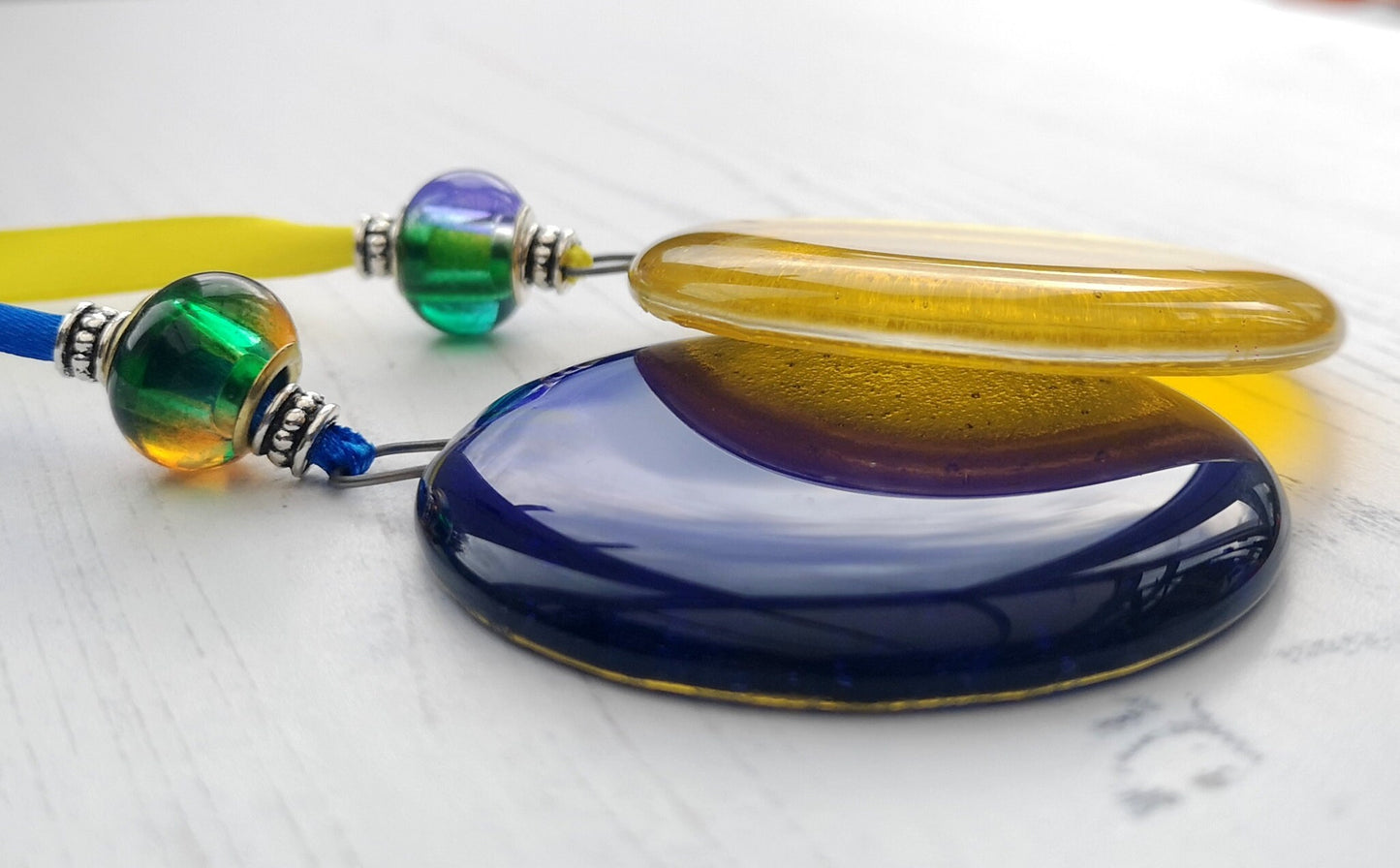 Handmade fused glass round rainbow coloured hanging Christmas tree decoration. Glass suncatcher bauble ornament, holiday decor gift, festive present.