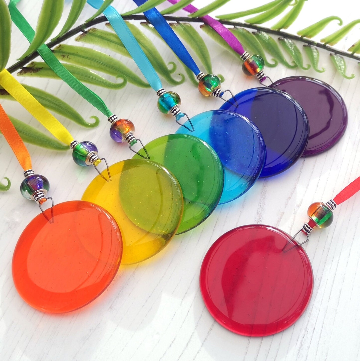 Handmade fused glass round rainbow coloured hanging Christmas tree decoration. Glass suncatcher bauble ornament, holiday decor gift, festive present.