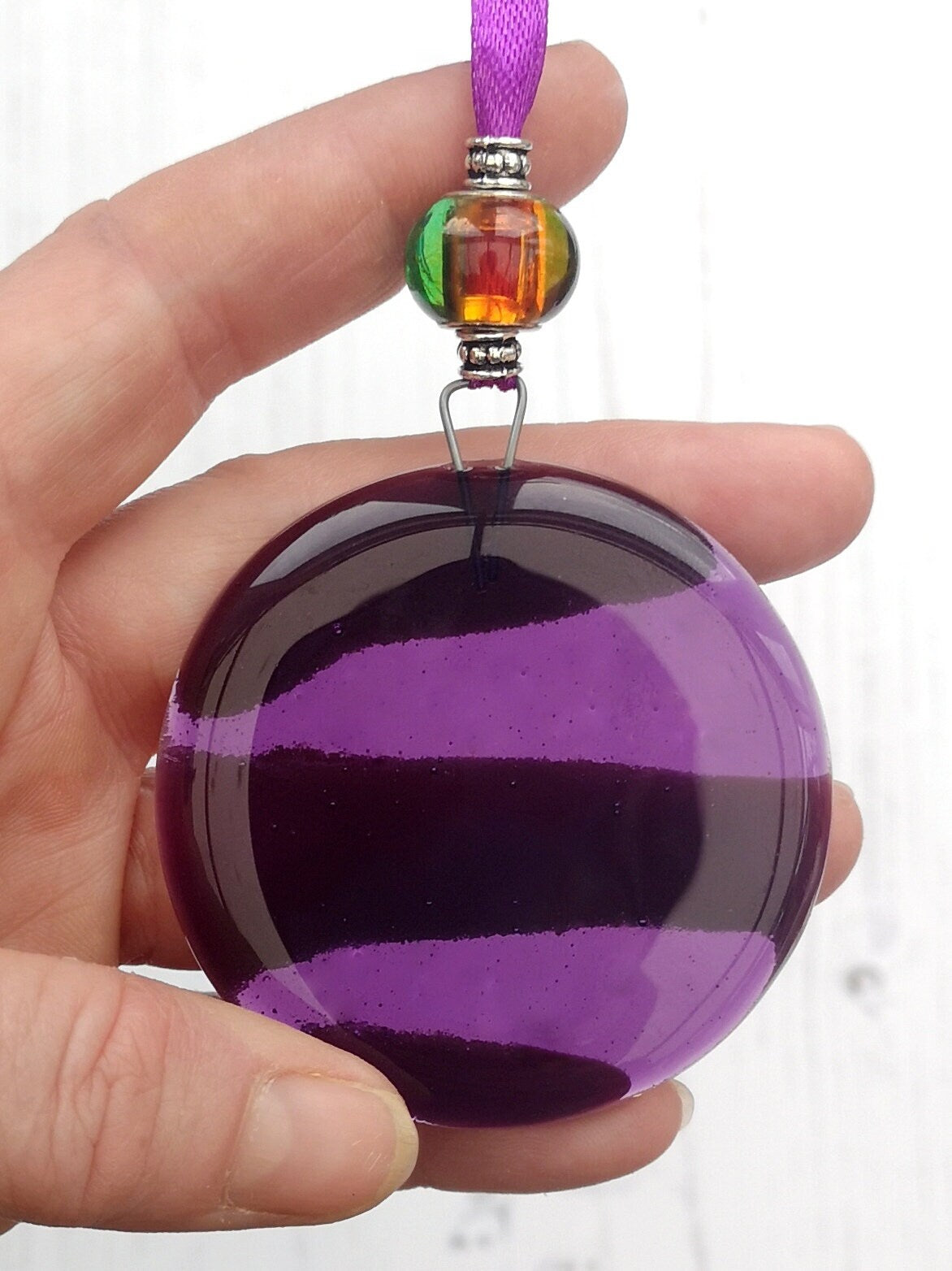 Handmade fused glass round rainbow coloured hanging Christmas tree decoration. Glass suncatcher bauble ornament, holiday decor gift, festive present.
