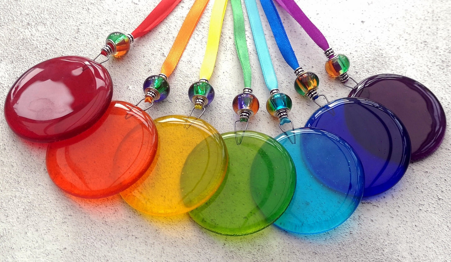 Handmade fused glass round rainbow coloured hanging Christmas tree decoration. Glass suncatcher bauble ornament, holiday decor gift, festive present.