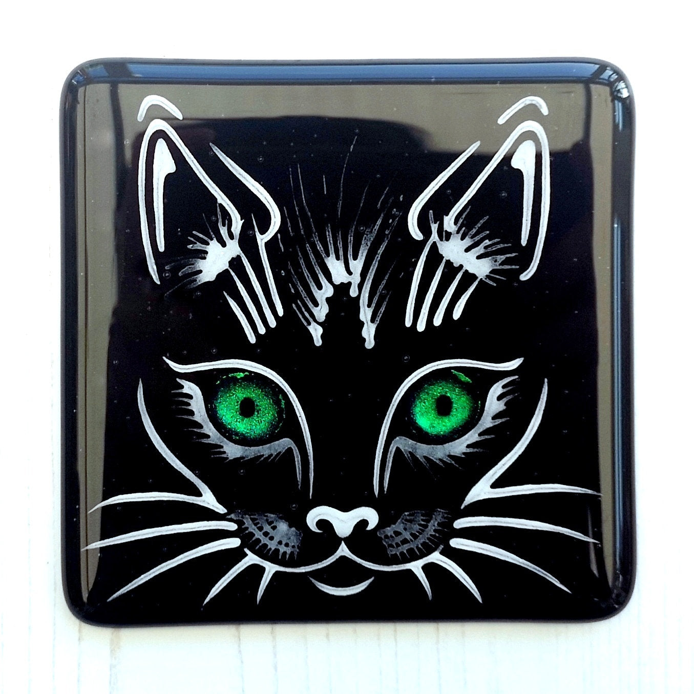 Handmade fused glass cat face drinks coaster with reflective dichroic glass eyes. Glass tile, lucky black cat. Hot drink table mat, feline decor gift. Lucky cat, crazy cat decoration, wall tile, kitten, kitty cat lover.