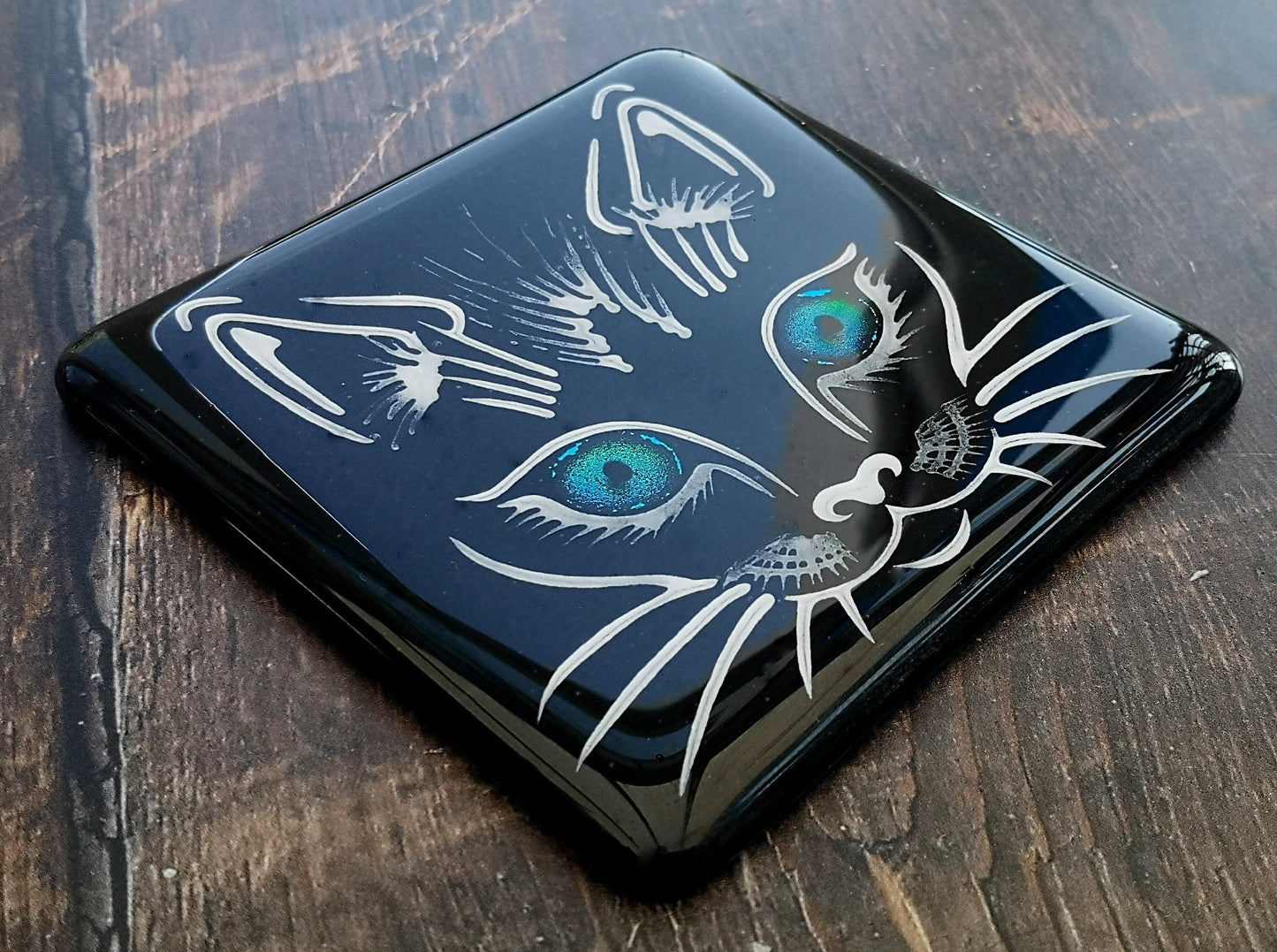 Handmade fused glass cat face drinks coaster with reflective dichroic glass eyes. Glass tile, lucky black cat. Hot drink table mat, feline decor gift. Lucky cat, crazy cat decoration, wall tile, kitten, kitty cat lover.