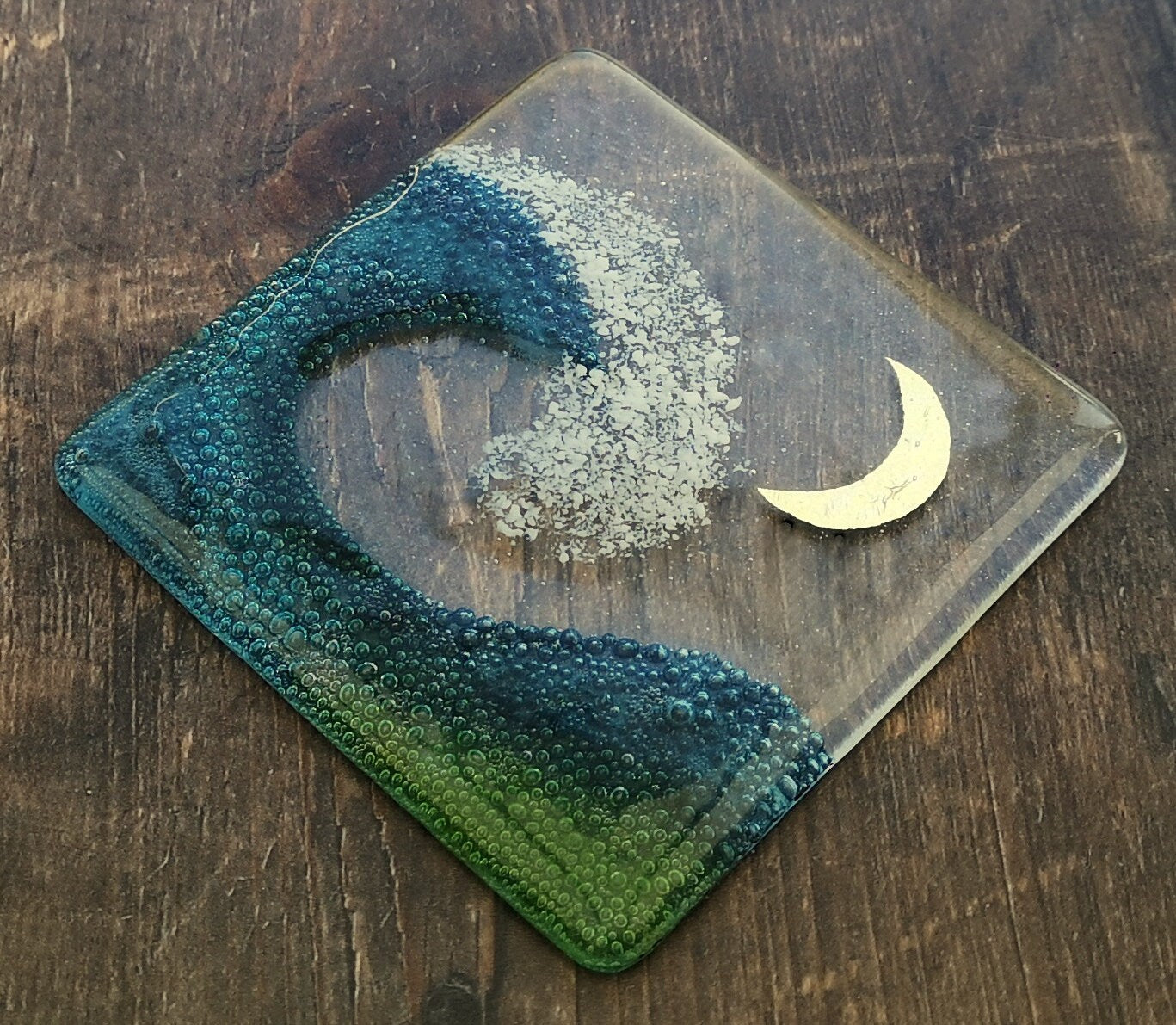 Handmade fused glass wave drinks coaster with embedded coloured bubbles and pure silver foil moon. Glass wall tile, hot drink table mat, sea, ocean home decoration, dining table protection. Beach gift.