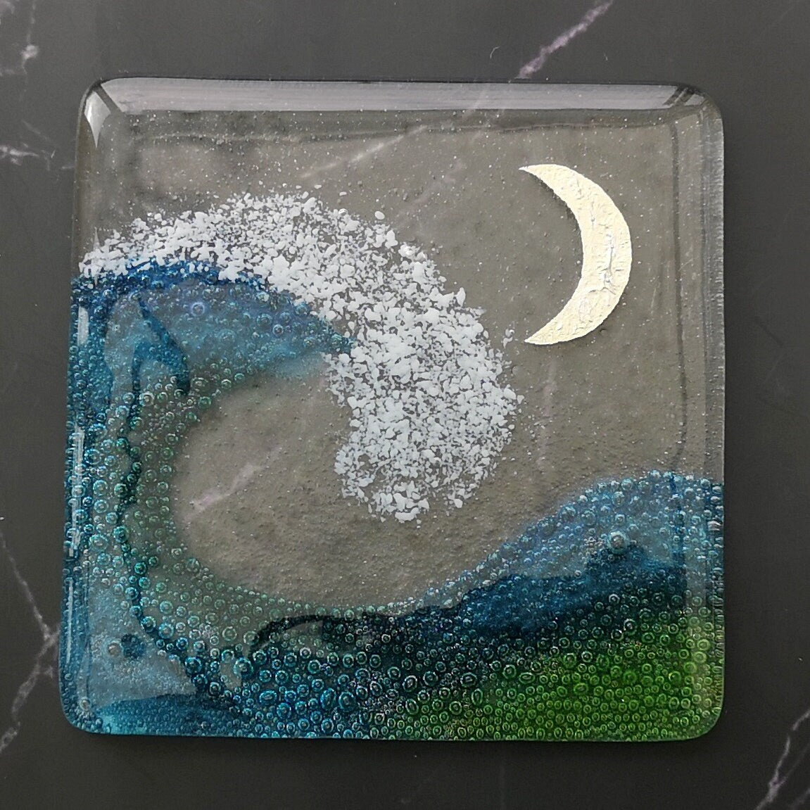 Handmade fused glass wave drinks coaster with embedded coloured bubbles and pure silver foil moon. Glass wall tile, hot drink table mat, sea, ocean home decoration, dining table protection. Beach gift.