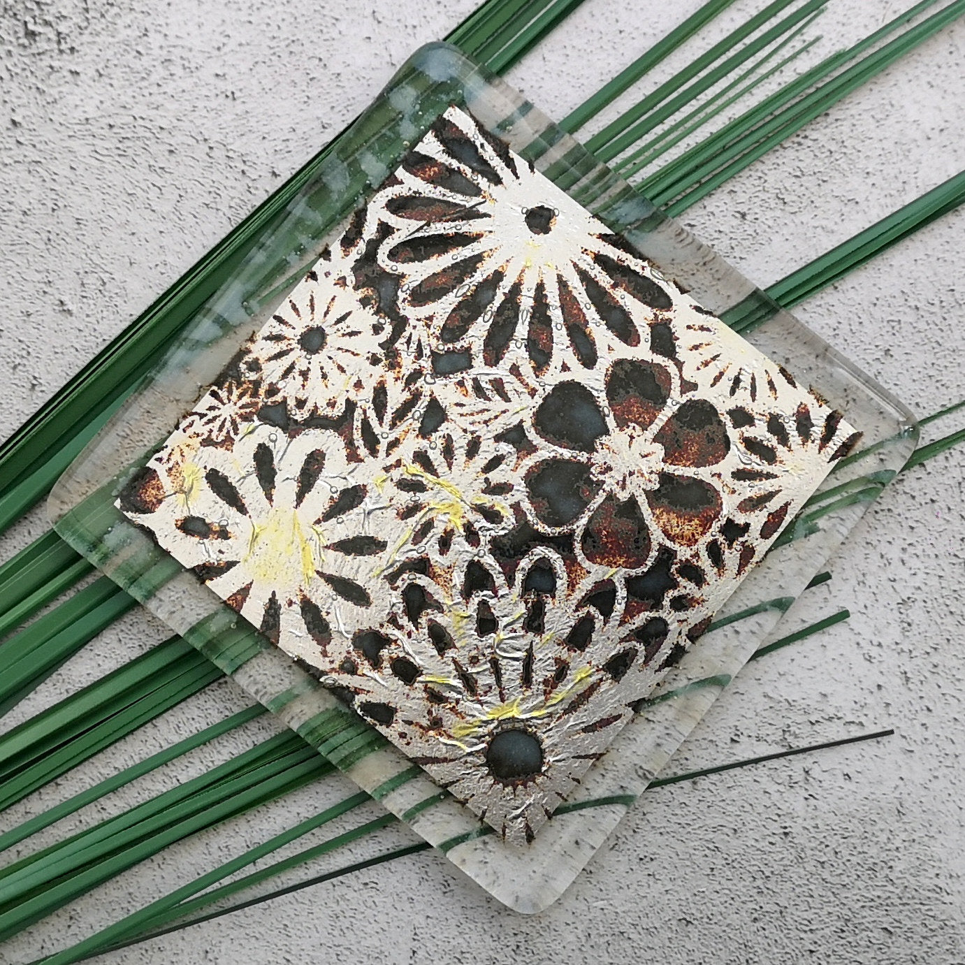 Handmade fused glass flowers on silver drinks coaster. Flower pattern design, glass tile art, hot drink table mat, floral nature gift. Embedded pure silver foil, wall tile home decoration, dining table protection.