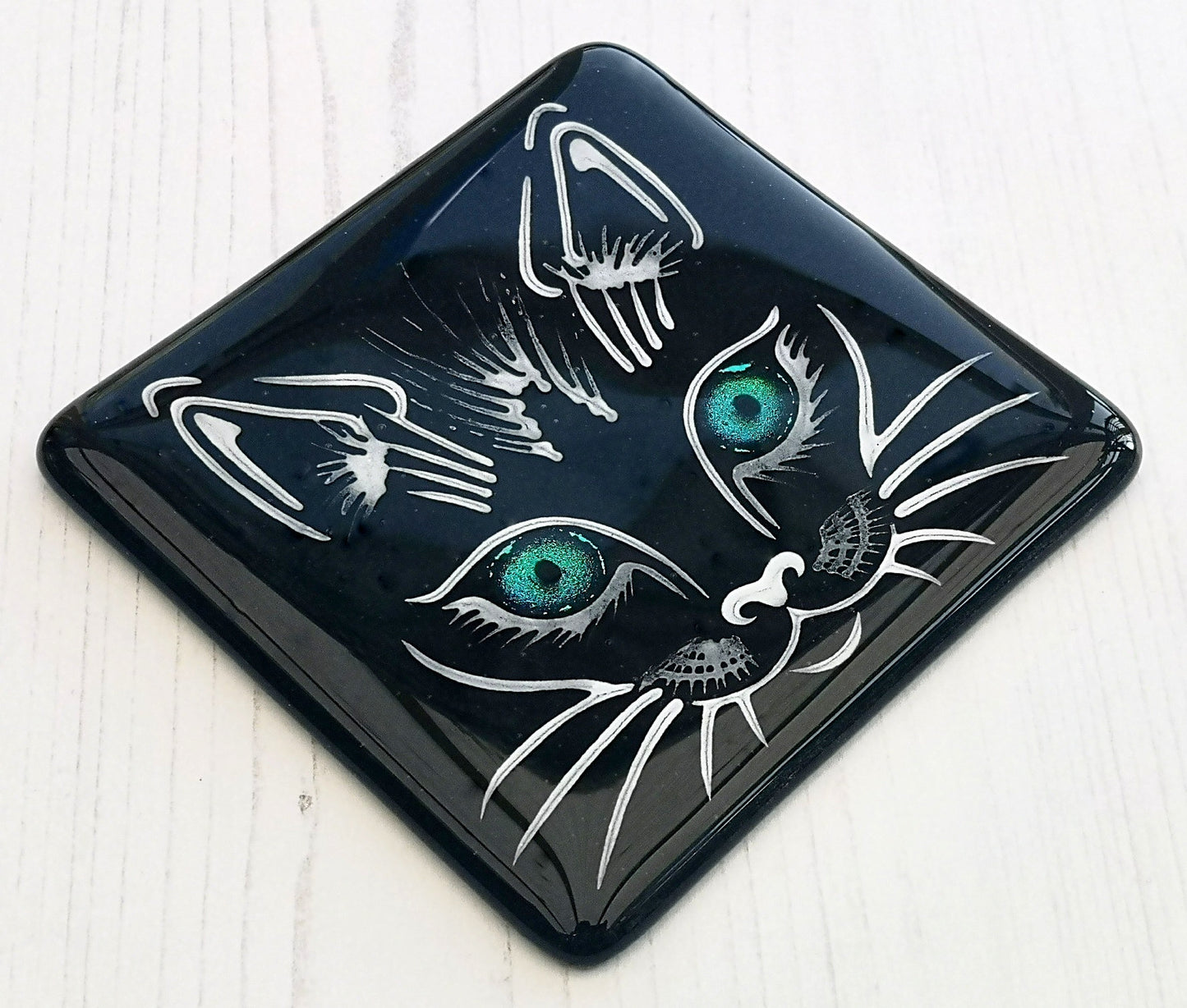 Handmade fused glass cat face drinks coaster with reflective dichroic glass eyes. Glass tile, lucky black cat. Hot drink table mat, feline decor gift. Lucky cat, crazy cat decoration, wall tile, kitten, kitty cat lover.