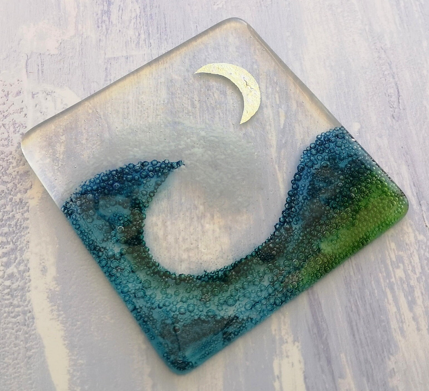 Handmade fused glass wave drinks coaster with embedded coloured bubbles and pure silver foil moon. Glass wall tile, hot drink table mat, sea, ocean home decoration, dining table protection. Beach gift.