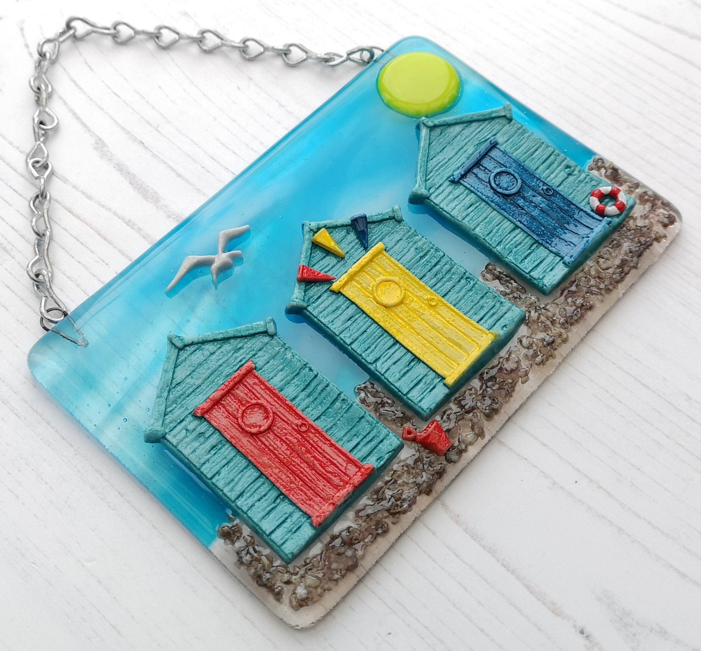 Handmade fused glass 3D Beach Huts Hanging Picture. Seaside wall art, beach gift decoration, sea ocean scene with glass pebbles, seagull, bucket and spade, bunting.