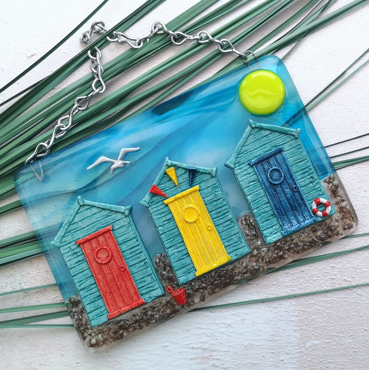 Handmade fused glass 3D Beach Huts Hanging Picture. Seaside wall art, beach gift decoration, sea ocean scene with glass pebbles, seagull, bucket and spade, bunting.