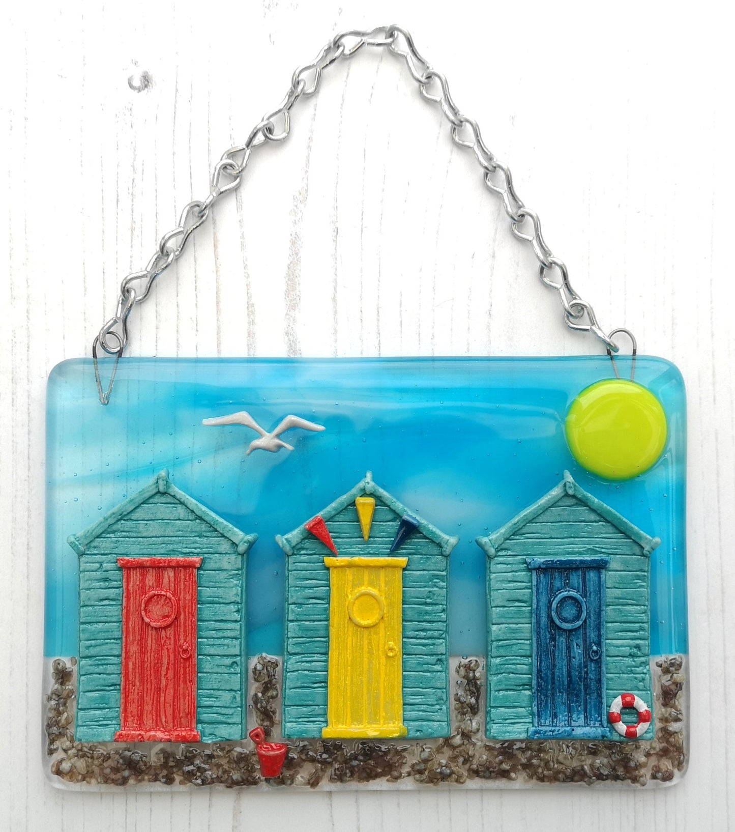 Handmade fused glass 3D Beach Huts Hanging Picture. Seaside wall art, beach gift decoration, sea ocean scene with glass pebbles, seagull, bucket and spade, bunting.
