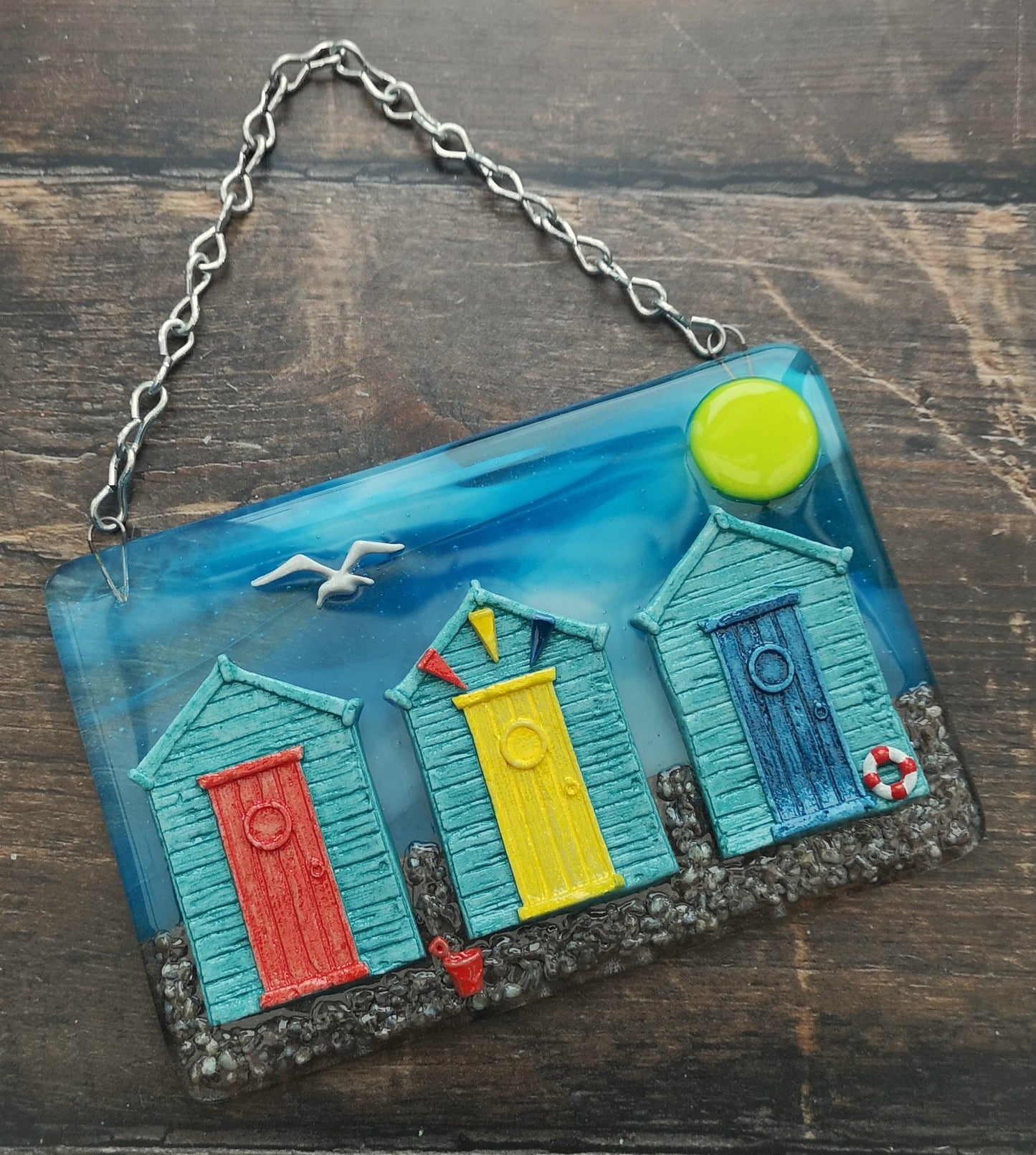 Handmade fused glass 3D Beach Huts Hanging Picture. Seaside wall art, beach gift decoration, sea ocean scene with glass pebbles, seagull, bucket and spade, bunting.