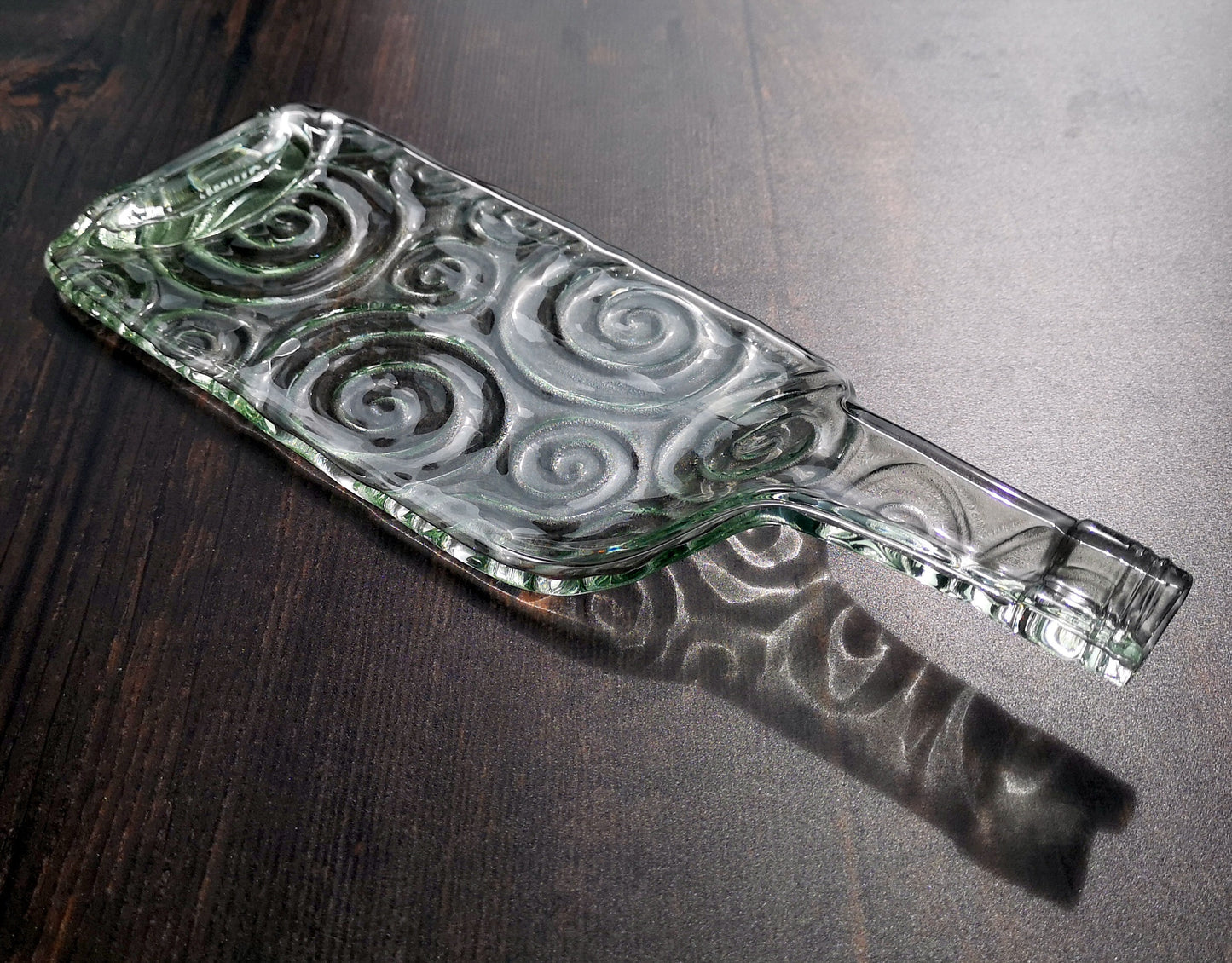 Handmade fused glass Recycled Wine Bottle Plate or Spatula Shape With Raised Neck Handle & Spiral Pattern. Squashed, slumped bottle serving dish. Eco gift, zero waste, reclaimed, upcycled glass platter.