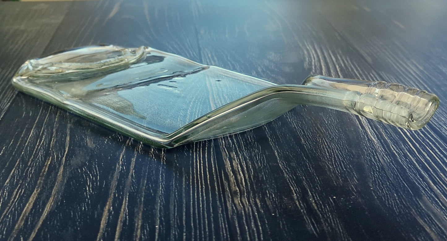 Handmade fused glass Recycled Wine Bottle Plate or Spatula With Raised Neck Handle. Squashed, slumped bottle serving dish. Eco gift, zero waste, reclaimed, upcycled glass platter.