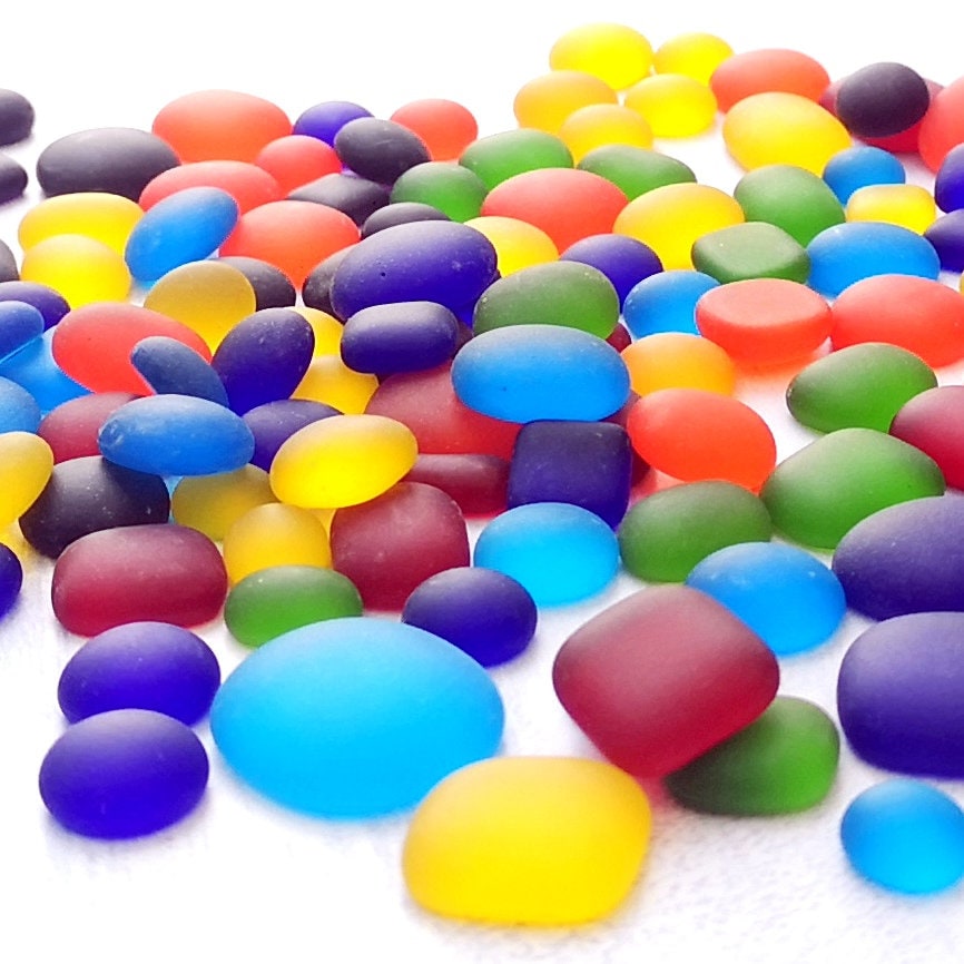 Close-up of colourful tumbled glass in rainbow hues, highlighting the frosted finish and varied shapes, perfect for creative DIY projects. Gift for artist.
