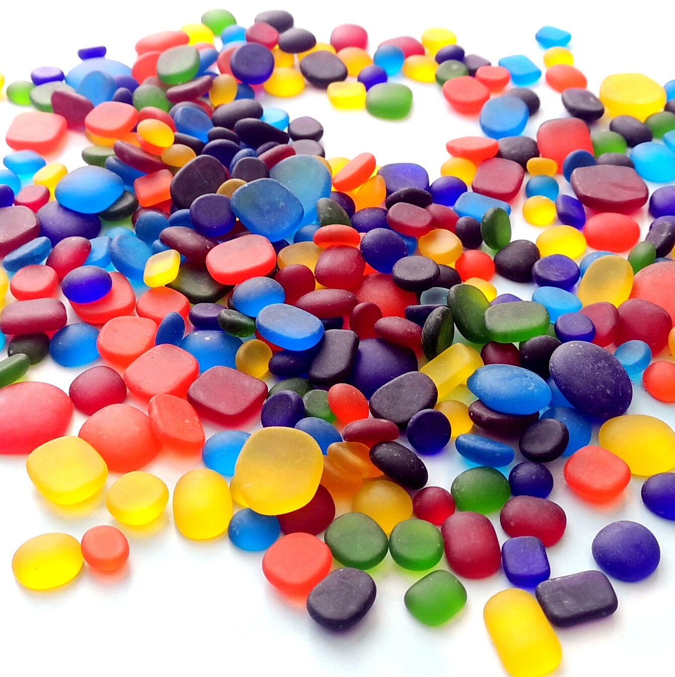 Eco-friendly rainbow tumbled glass assortment, highlighting their sustainable appeal and varied hues