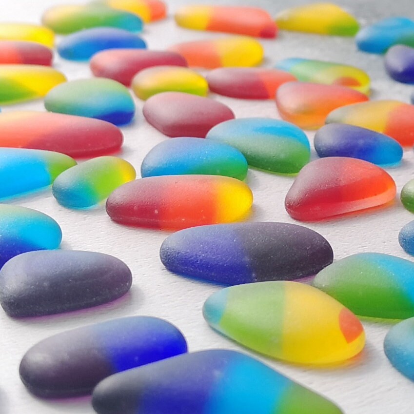 Close-up view of assorted tumbled glass in various colours, highlighting their unique frosted textures and shapes, perfect for DIY projects