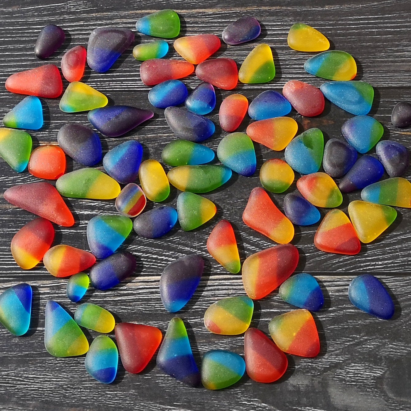 Creative multicolored tumbled glass, on a dark background. Showing their weathered smooth look, with many uses in home decor crafts
