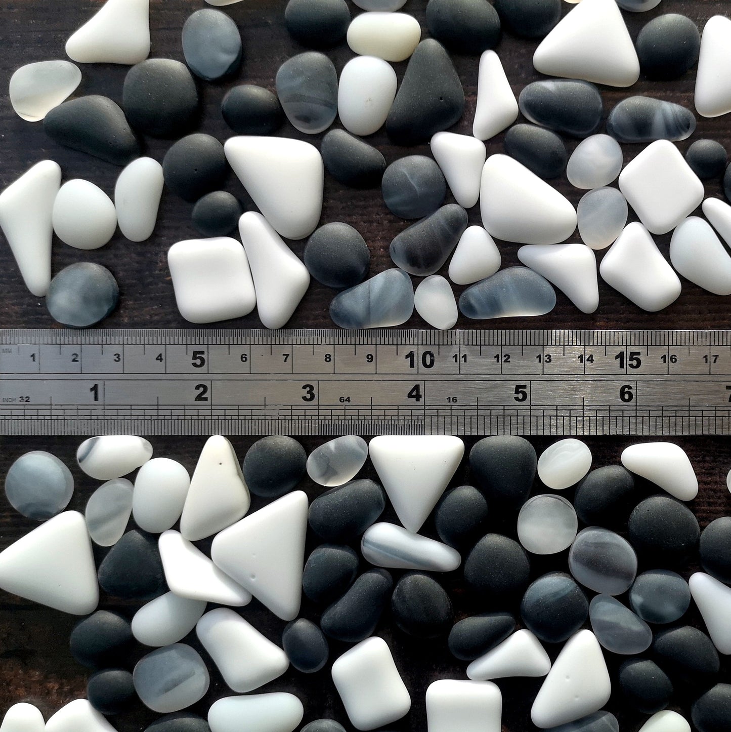 Creative inspiration with black and white frosted tumbled glass, shown next to a ruler, illustrating their versatility in crafts.