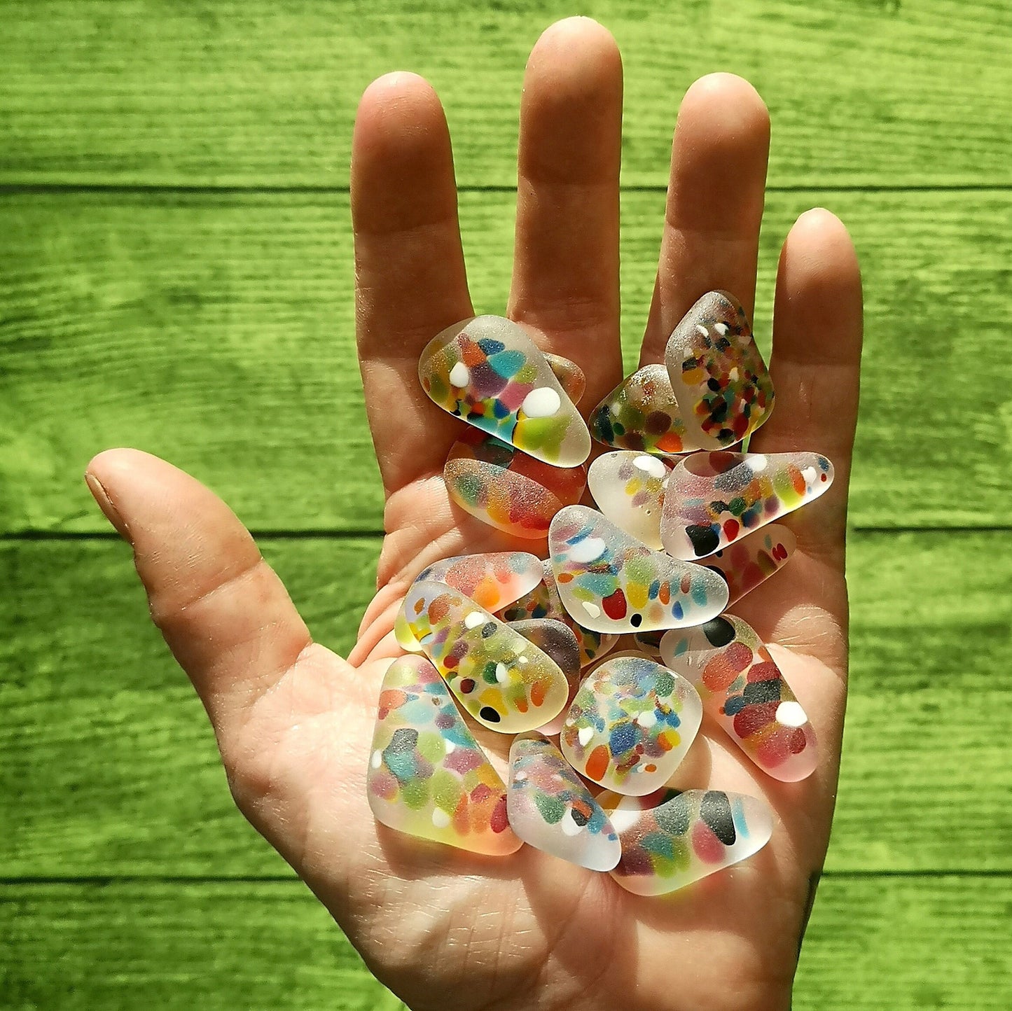 A Handful of Spotty Coloured Seaglass. Dive into Creativity: Multicolored Tumbled Glass for Crafting