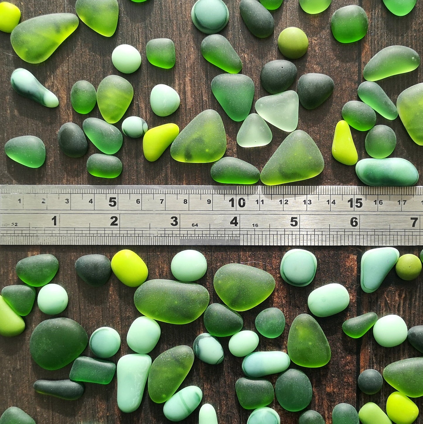 Artistic inspiration with green tumbled glass, perfect for a home decor project, versatile use in DIY craft projects. Shown next to ruler for size.